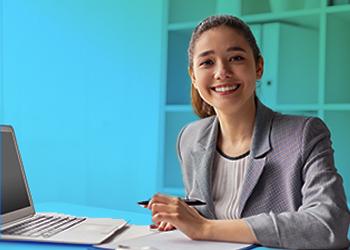 student smiling with laptop